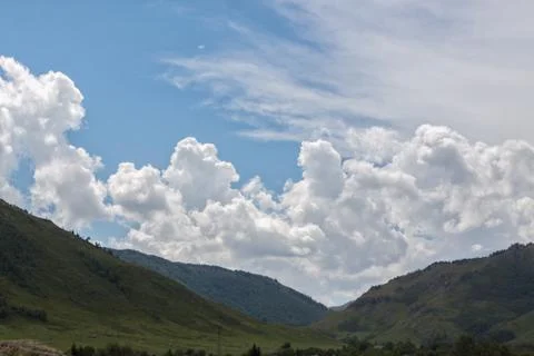Beautiful clouds over the mountains Stock Photos