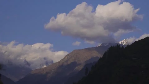 Beautiful clouds over snow mountains in the azure blue skies. Video stock 280261776