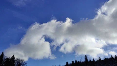 Beautiful clouds passing in the blue sky on a winter day with sun Stock Footage 170389132