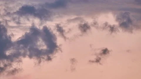 Beautiful clouds quickly swim around sky. Pink sky illuminated by setting sun Stock Footage 208860526