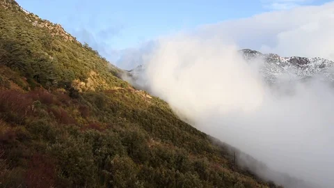 Beautiful clouds rising a mountain Stock Footage 129751608