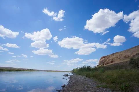 Beautiful clouds in the river valley Stock Photos