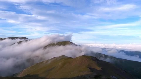 Beautiful clouds rolling over the mountains Stock Footage 142749870