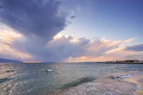 Beautiful clouds with the setting sun over the sea Stock Photos