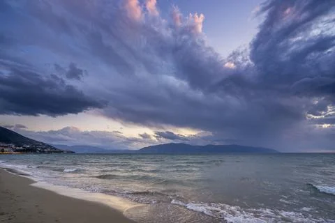 Beautiful clouds with the setting sun over the sea Stock Photos