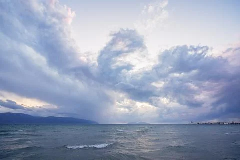 Beautiful clouds with the setting sun over the sea Stock Photos