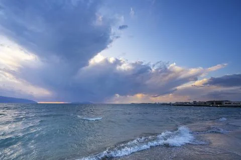 Beautiful clouds with the setting sun over the sea Stock Photos