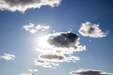 Beautiful clouds in the sky. Clouds in the blue sky with a sun light. A mirac Stock Photos