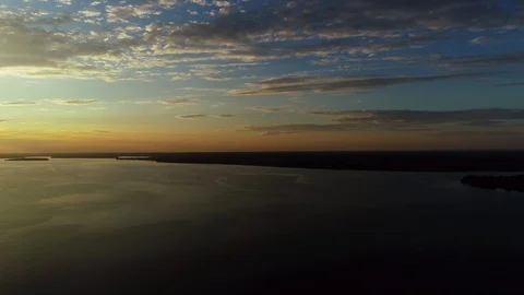 Beautiful cloudscape and sunset breaking through cloud over lake reflection. Stock Footage 104669721