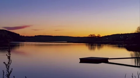 Beautiful cloudscape and sunset over lake reflection. pier. Stock Footage 165027271