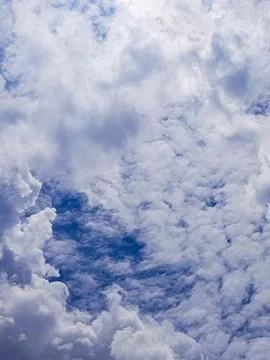 A beautiful cloudscape featuring fluffy white clouds scattered across a bright Foto stock