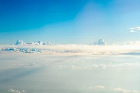 Beautiful cloudscape featuring a gradient blue sky and soft white clouds, c.. Stock Photos