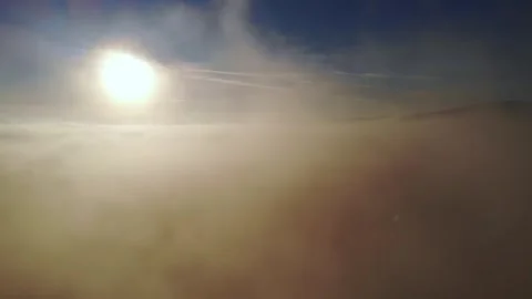 Beautiful cloudscape. Flying out of the clouds during the sunrise. Stock Footage 271675444