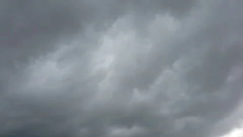 Beautiful cloudscape with large, building clouds and sunrise Stock Footage