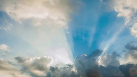 Beautiful cloudscape with large, building clouds and sunrise breaking through cl Video stock 77111276