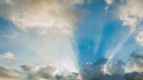 Beautiful cloudscape with large, building clouds and sunrise breaking through cl Stock-Footage 77111303