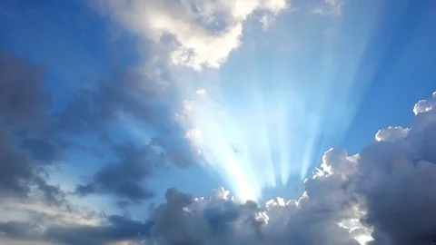 Beautiful cloudscape with large, building clouds and sunrise breaking through cl Stock-Footage 77115651