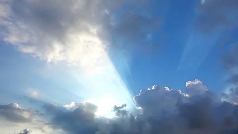 Beautiful cloudscape with large, building clouds and sunrise breaking through cl Stock-Footage 77115667