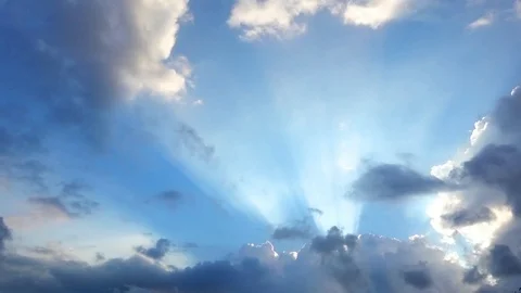Beautiful cloudscape with large, building clouds and sunrise breaking through cl Video stock 77115672