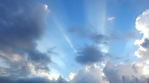 Beautiful cloudscape with large, building clouds and sunrise breaking through cl Video stock 77115676
