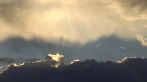 Beautiful cloudscape with large clouds and sunrise breaking through cloud mass Stock Footage 81875771