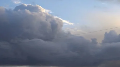 Beautiful cloudscape with large clouds and sunrise breaking through cloud mass Stock Footage 81876114