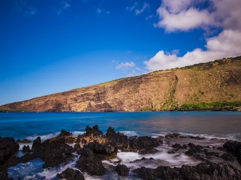 Beautiful cloudscape moving over mountain range with ocean waves - 4K Stock Footage 72457265