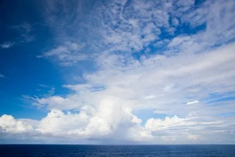 Beautiful cloudscape over a blue ocean Stock Photos