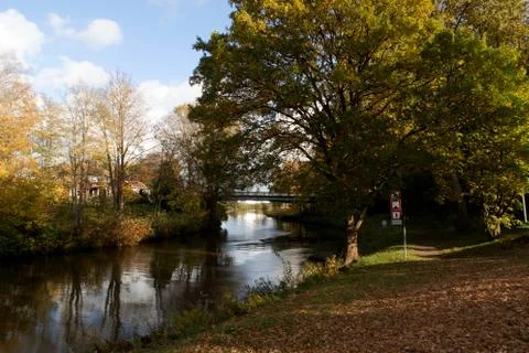 A beautiful cloudscape over a calm Ems canal with a narrow bridge walkway in  Stock Photos