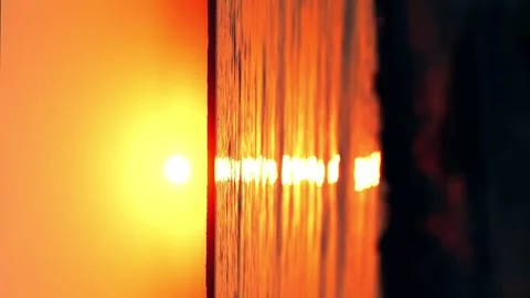 Beautiful cloudscape over the sea, bright orange sunset time lapse vertical Stock Footage 256993900