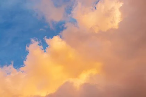 Beautiful cloudscape - pink-orange clouds in the rays of the sun against the  Stock Photos