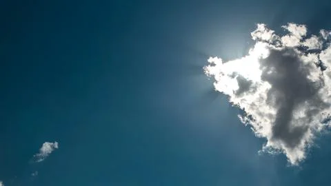 Beautiful cloudscape timelapse with large, building clouds and sunrise breaki Stock Photos