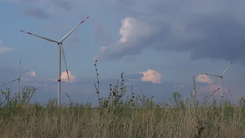 Beautiful cloudy sky over alternative renewable wind energy power generator Stock Footage 94534761