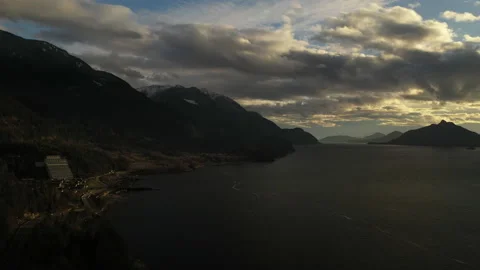 Beautiful Cloudy Sunset Next to Mountains Lake and Highway Stock Footage 206900623