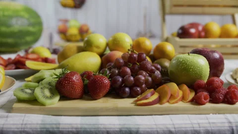 Beautiful cluster of delicious fruit on cutting board in kitchen - medium shot Stock Footage 341233875