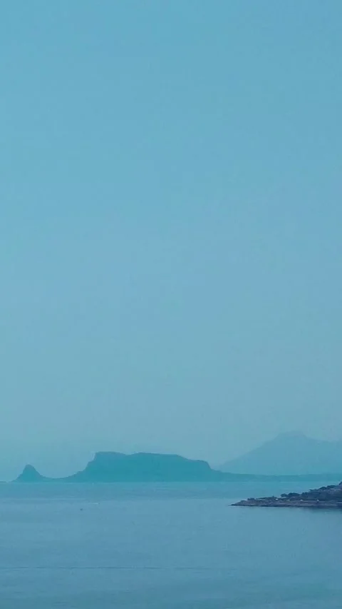 Beautiful Coastal View With Distant Islands and Clear Blue Skies Over Calm Stock Footage 316166751