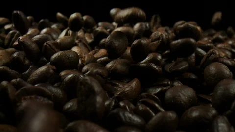 Beautiful coffee beans moving in front of slowmotion camera Video stock 99059668