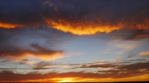 Beautiful color filled time lapse of the setting sun and large clouds. Stock Footage 55832461