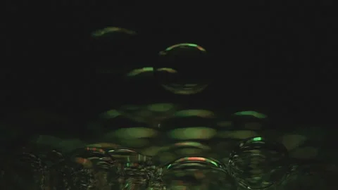 Beautiful colored bubbles in a liquid on a black background. Close-up. Slow Video stock 97847686