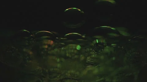 Beautiful colored bubbles in a liquid on a black background. Close-up. Slow 스톡 동영상 97847762
