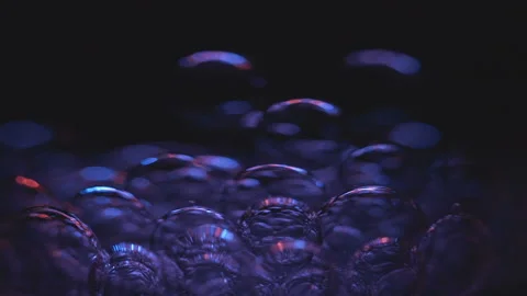 Beautiful colored bubbles in a liquid on a black background. Close-up. Slow Stock Footage 97848137