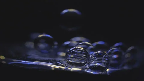 Beautiful colored bubbles in a liquid on a black background. Close-up. Slow Video stock 97848198