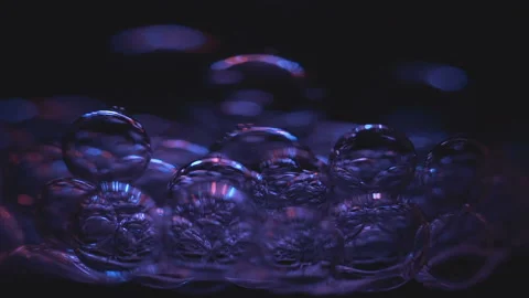 Beautiful colored bubbles in a liquid on a black background. Close-up. Slow Video stock 97848211