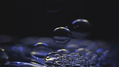 Beautiful colored bubbles in a liquid on a black background. Close-up. Slow Video stock 97849621