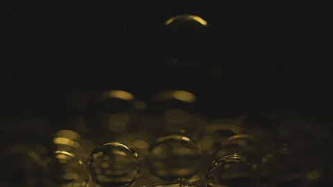 Beautiful colored bubbles in a liquid on a black background. Close-up. Slow Stock Footage 97849728