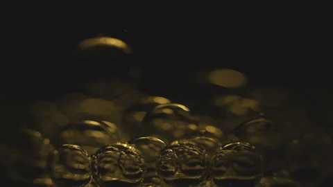 Beautiful colored bubbles in a liquid on a black background. Close-up. Slow Stock Footage 97849739