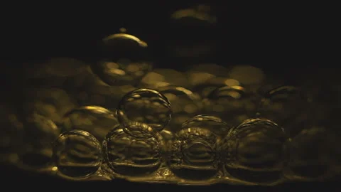 Beautiful colored bubbles in a liquid on a black background. Close-up. Slow Stock Footage 97849756