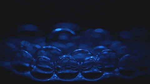 Beautiful colored bubbles in a liquid on a black background. Close-up. Slow 動画素材 97849808