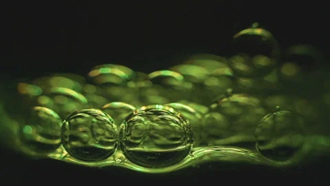 Beautiful colored bubbles in a liquid on a black background. Close-up. Slow Video stock 97849850