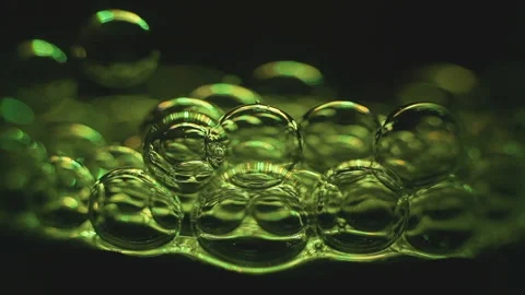 Beautiful colored bubbles in a liquid on a black background. Close-up. Slow Stock Footage 97849866